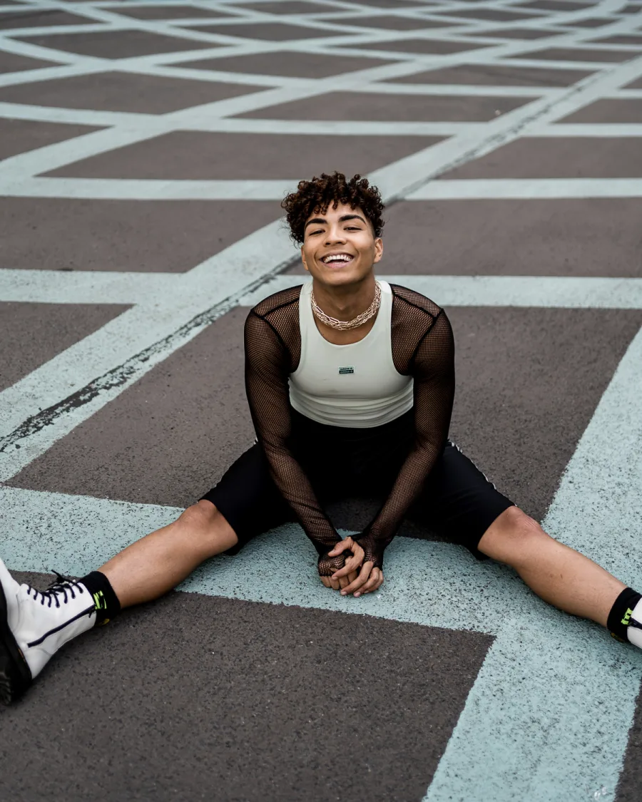 Young person in white and black athletic wear on geometric parking lot pattern