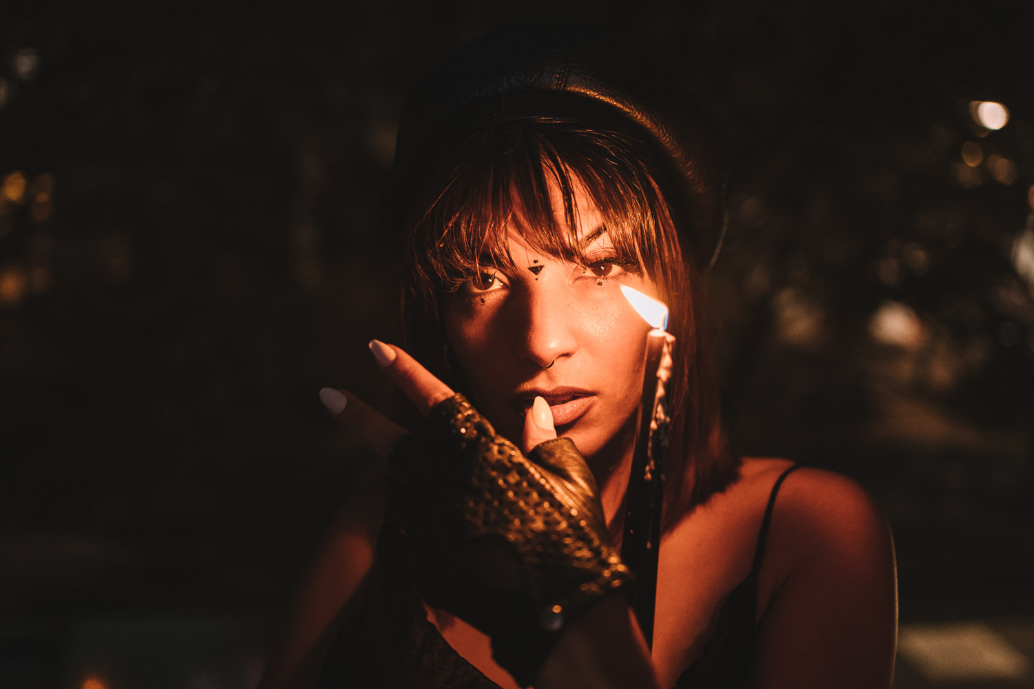 Woman with dark hair and bangs captured in warm golden hour lighting
